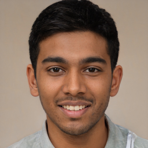 Joyful latino young-adult male with short  black hair and brown eyes