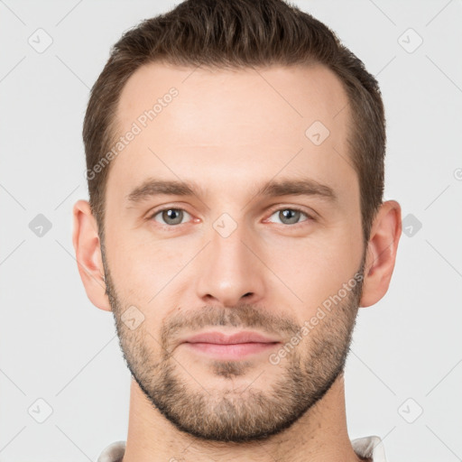 Joyful white young-adult male with short  brown hair and grey eyes