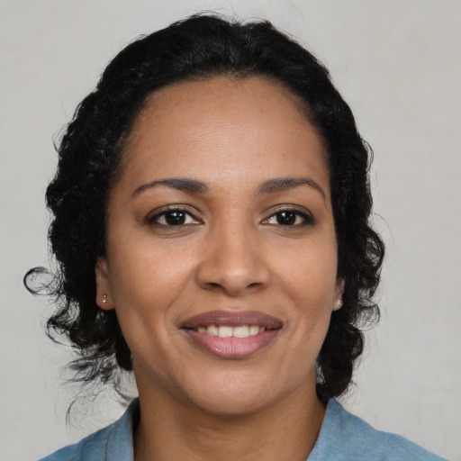 Joyful latino young-adult female with medium  black hair and brown eyes