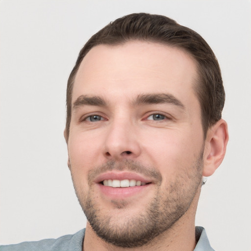 Joyful white young-adult male with short  brown hair and brown eyes