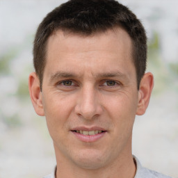 Joyful white adult male with short  brown hair and brown eyes