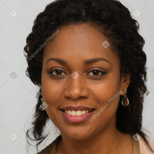 Joyful black young-adult female with long  black hair and brown eyes