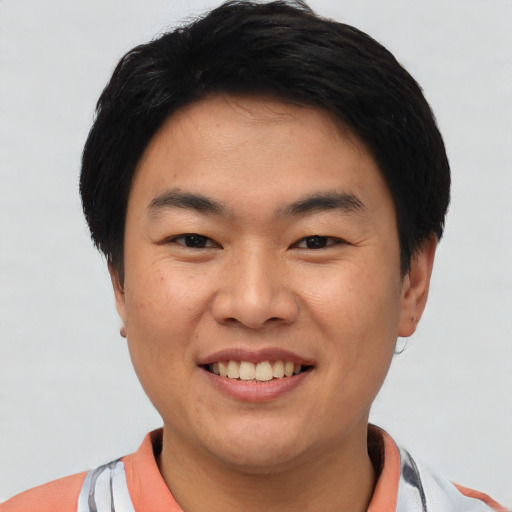 Joyful asian young-adult male with short  black hair and brown eyes