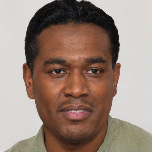 Joyful black young-adult male with short  black hair and brown eyes