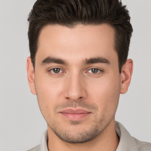 Joyful white young-adult male with short  brown hair and brown eyes