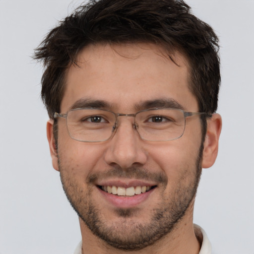 Joyful white adult male with short  brown hair and brown eyes