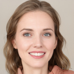 Joyful white young-adult female with medium  brown hair and blue eyes