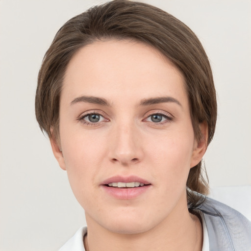 Joyful white young-adult female with medium  brown hair and grey eyes