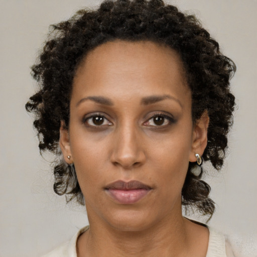 Neutral black young-adult female with medium  brown hair and brown eyes