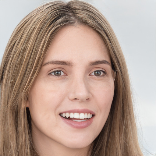 Joyful white young-adult female with long  brown hair and green eyes