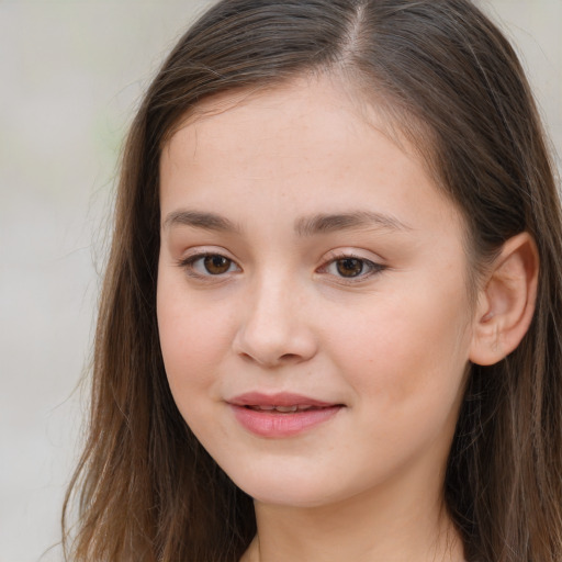 Joyful white child female with long  brown hair and brown eyes