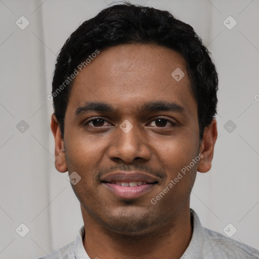 Joyful black young-adult male with short  black hair and brown eyes