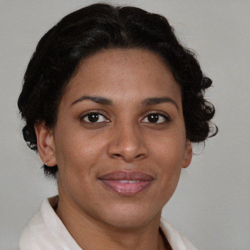 Joyful latino adult female with short  brown hair and brown eyes