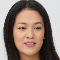 Joyful asian young-adult female with long  brown hair and brown eyes