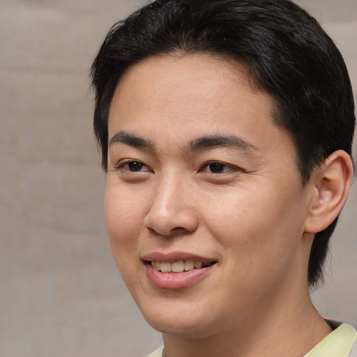 Joyful asian young-adult male with short  brown hair and brown eyes