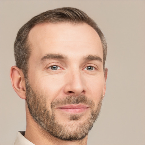 Joyful white adult male with short  brown hair and brown eyes