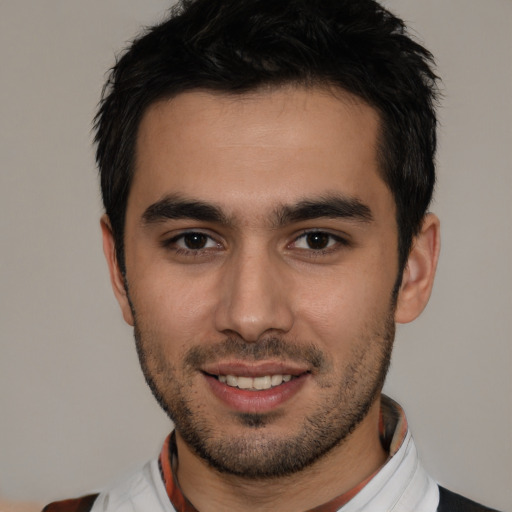 Joyful white young-adult male with short  black hair and brown eyes