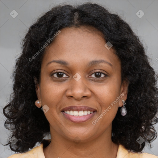 Joyful black young-adult female with long  brown hair and brown eyes