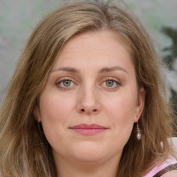 Joyful white young-adult female with medium  brown hair and green eyes