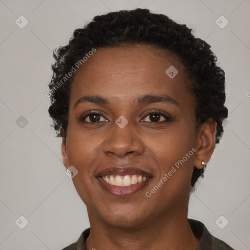 Joyful black young-adult female with short  brown hair and brown eyes