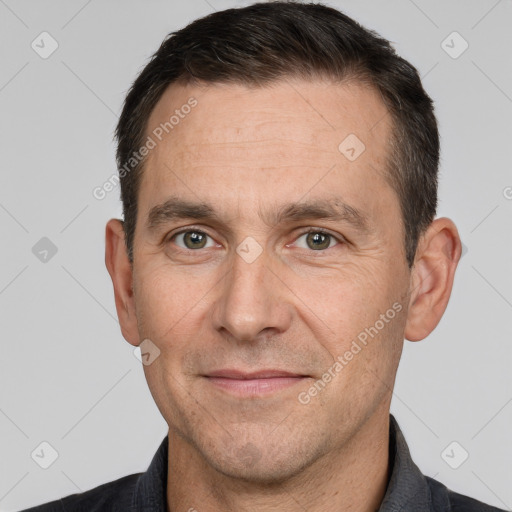 Joyful white adult male with short  brown hair and brown eyes