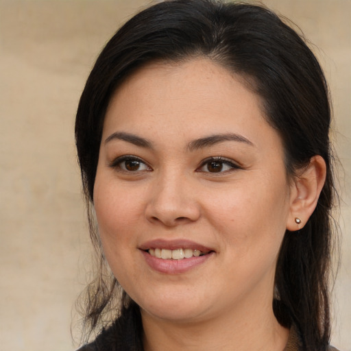 Joyful asian young-adult female with long  brown hair and brown eyes