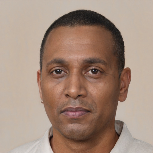 Neutral black adult male with short  black hair and brown eyes