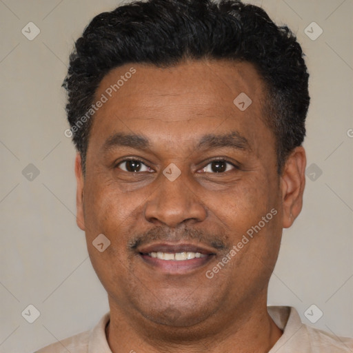 Joyful latino adult male with short  black hair and brown eyes
