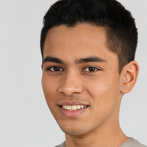 Joyful white young-adult male with short  black hair and brown eyes