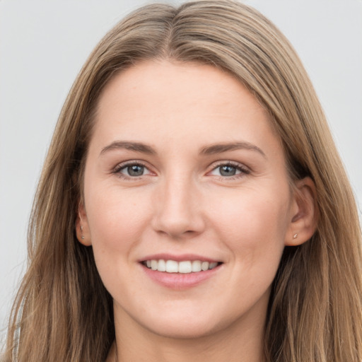 Joyful white young-adult female with long  brown hair and grey eyes