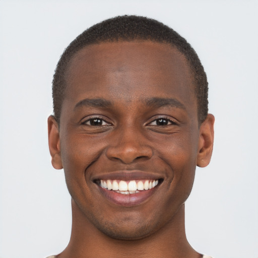 Joyful black young-adult male with short  brown hair and brown eyes