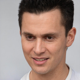 Joyful white young-adult male with short  brown hair and brown eyes