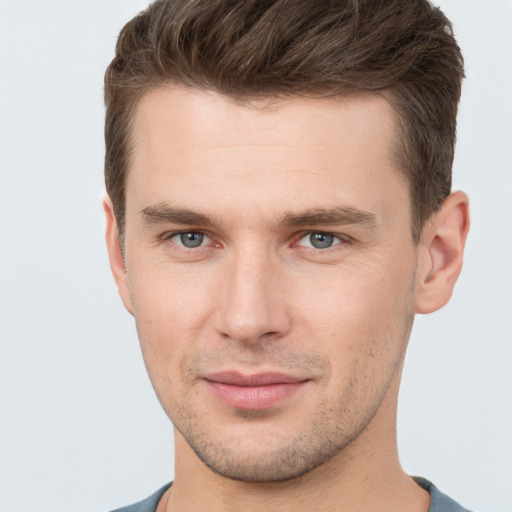 Joyful white young-adult male with short  brown hair and brown eyes