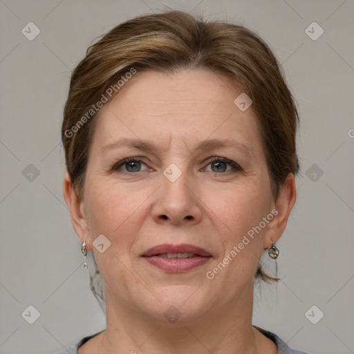 Joyful white adult female with medium  brown hair and grey eyes