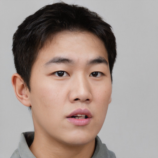 Neutral asian young-adult male with short  brown hair and brown eyes
