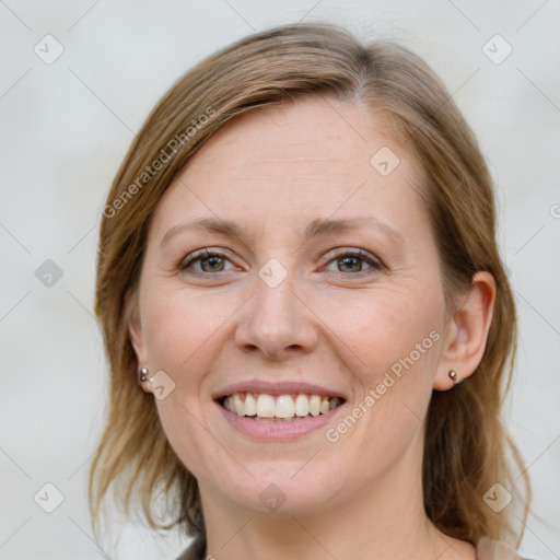 Joyful white young-adult female with medium  brown hair and blue eyes