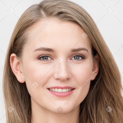 Joyful white young-adult female with long  brown hair and blue eyes