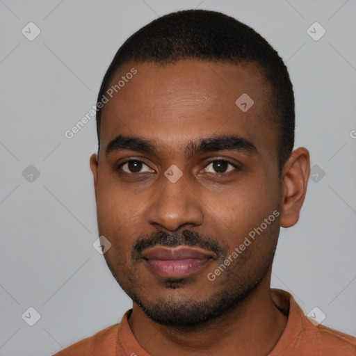 Joyful black young-adult male with short  black hair and brown eyes