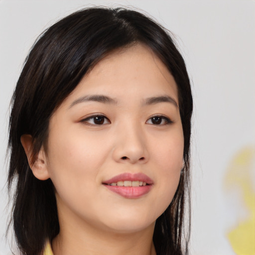 Joyful asian young-adult female with long  brown hair and brown eyes