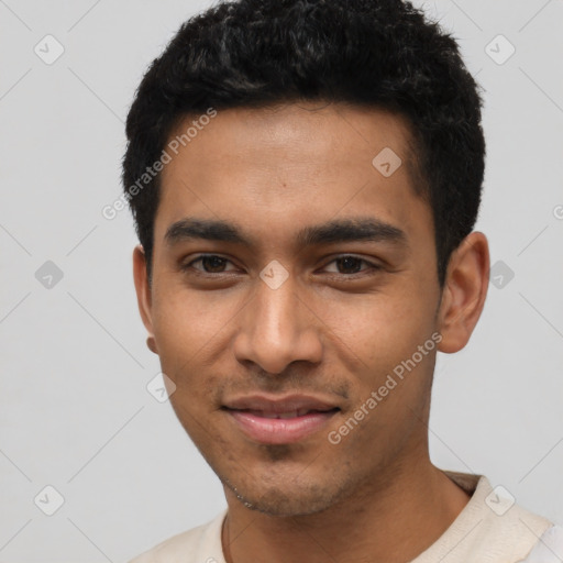 Joyful latino young-adult male with short  black hair and brown eyes