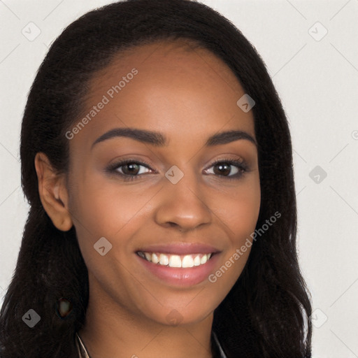 Joyful black young-adult female with long  brown hair and brown eyes