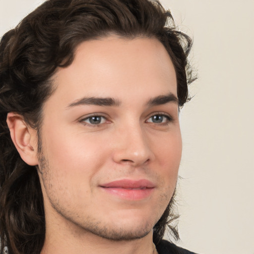 Joyful white young-adult male with medium  brown hair and brown eyes