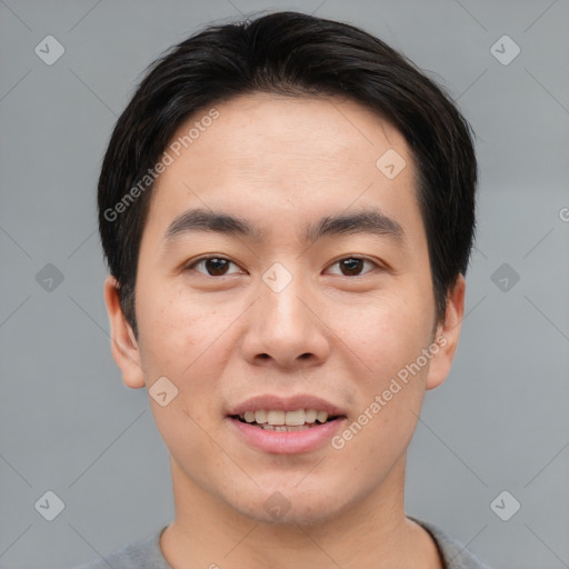 Joyful asian young-adult male with short  brown hair and brown eyes