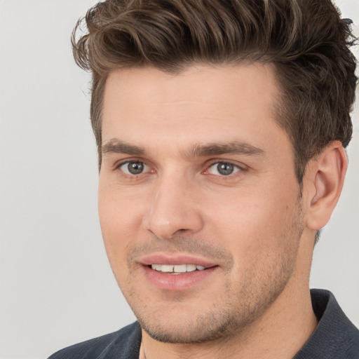 Joyful white young-adult male with short  brown hair and brown eyes