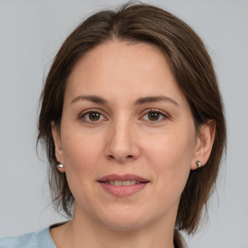 Joyful white adult female with medium  brown hair and brown eyes