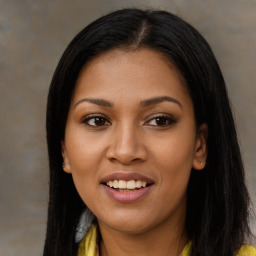 Joyful black young-adult female with long  brown hair and brown eyes