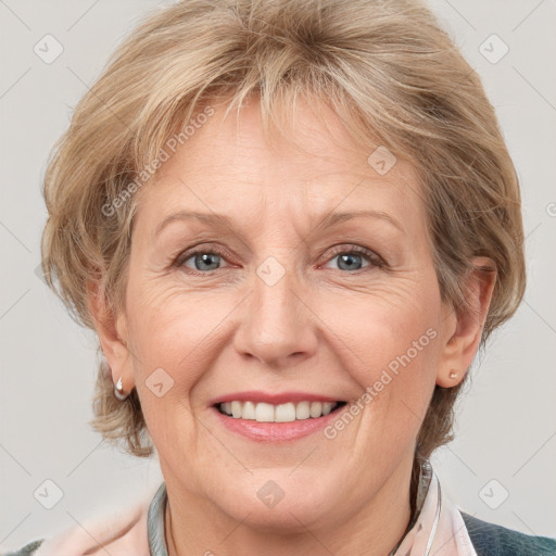 Joyful white adult female with medium  brown hair and grey eyes