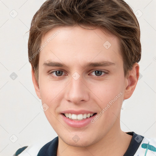 Joyful white young-adult male with short  brown hair and grey eyes