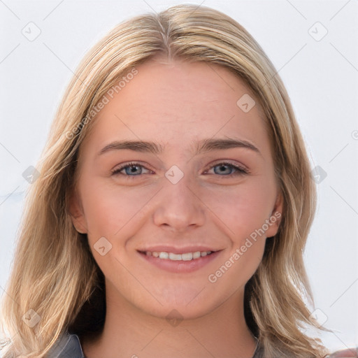 Joyful white young-adult female with long  brown hair and blue eyes