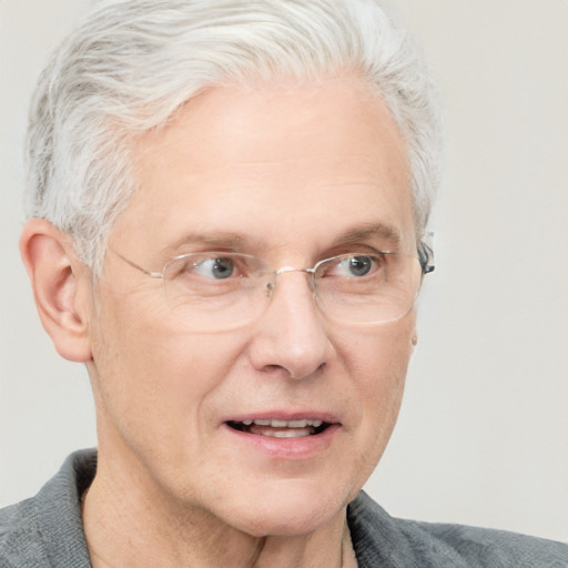 Joyful white middle-aged male with short  gray hair and blue eyes